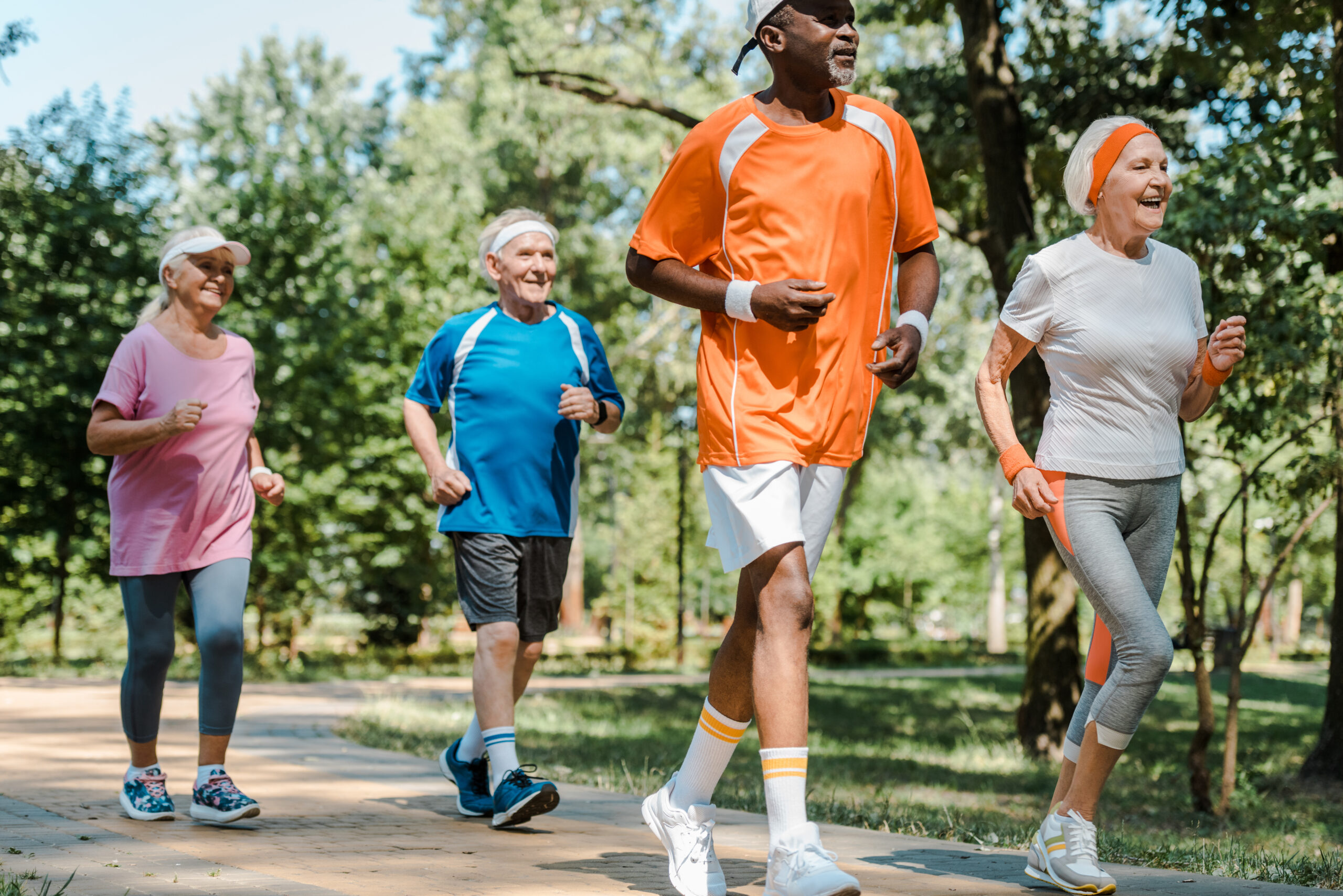 Sportive multicultural retired people in active clothes enjoying a jog